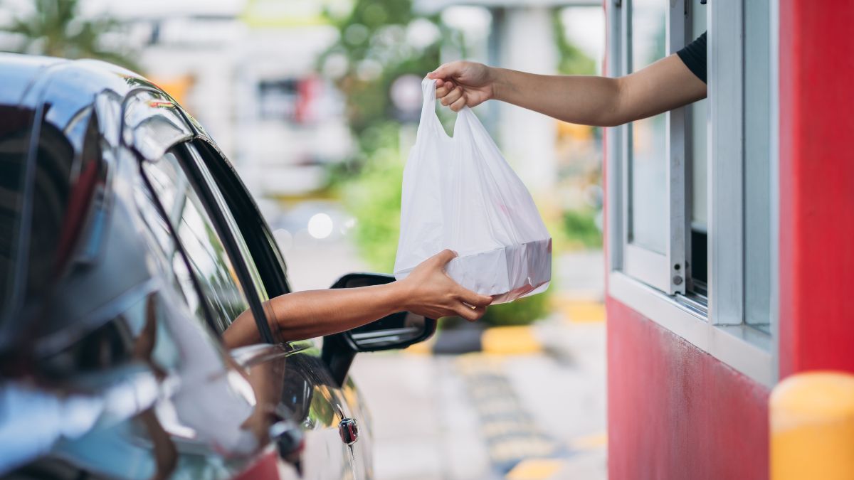 pessoa pegando lanche em drive thru
